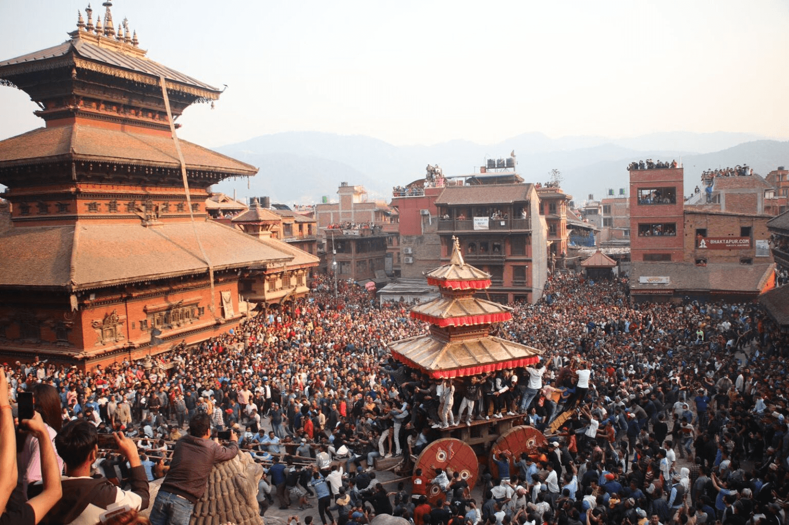 Colorful prayer flags fluttering at a historic temple in Kathmandu, Nepal, showcasing rich culture.