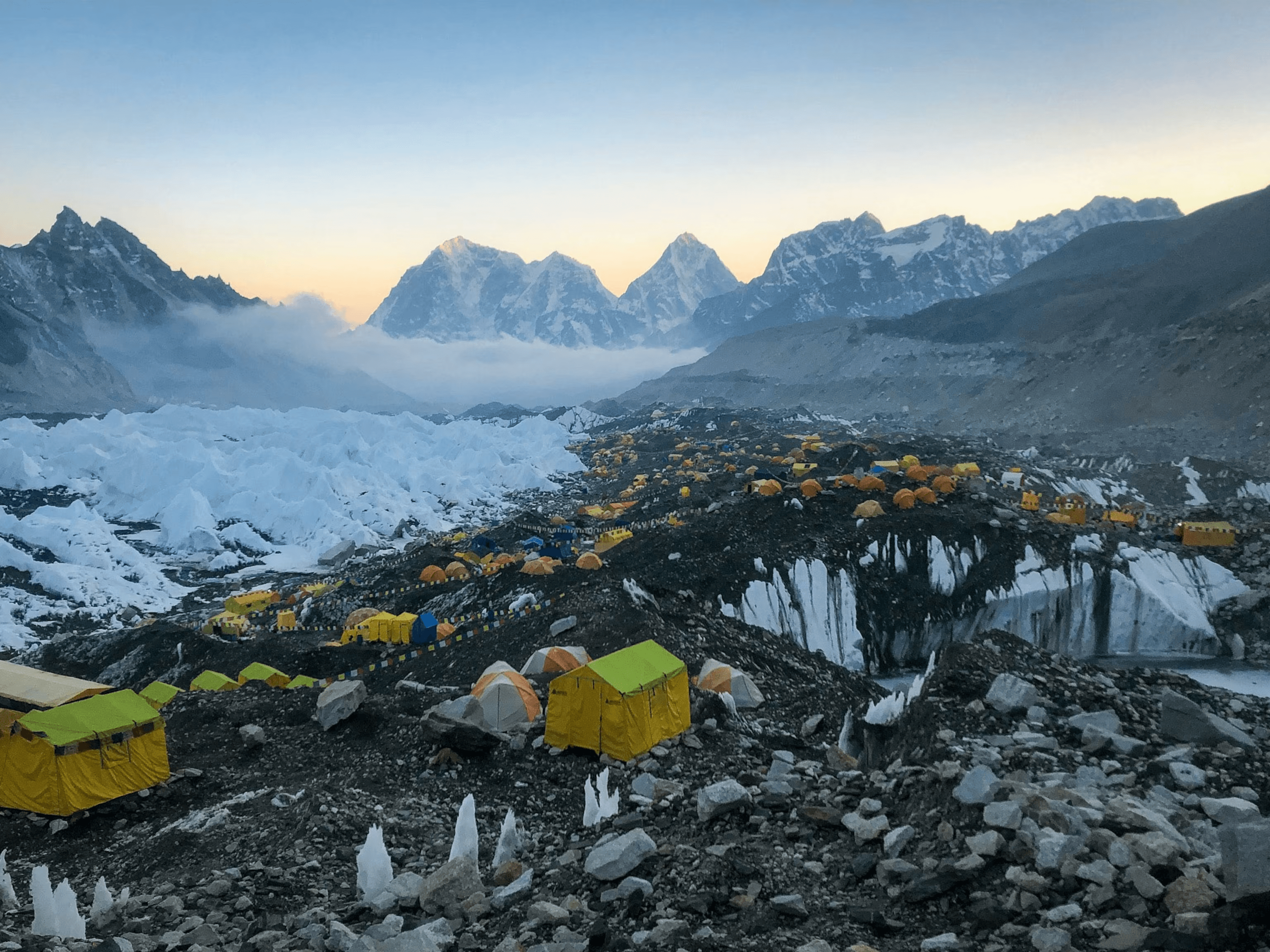 Trekkers approaching a snow-capped peak in the Himalayas, representing adventure travel in Nepal.